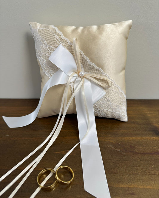 Almofadinha para alianças em cetim champagne com detalhe em renda e laço central. Modelo clássico e delicado da Etiquette.