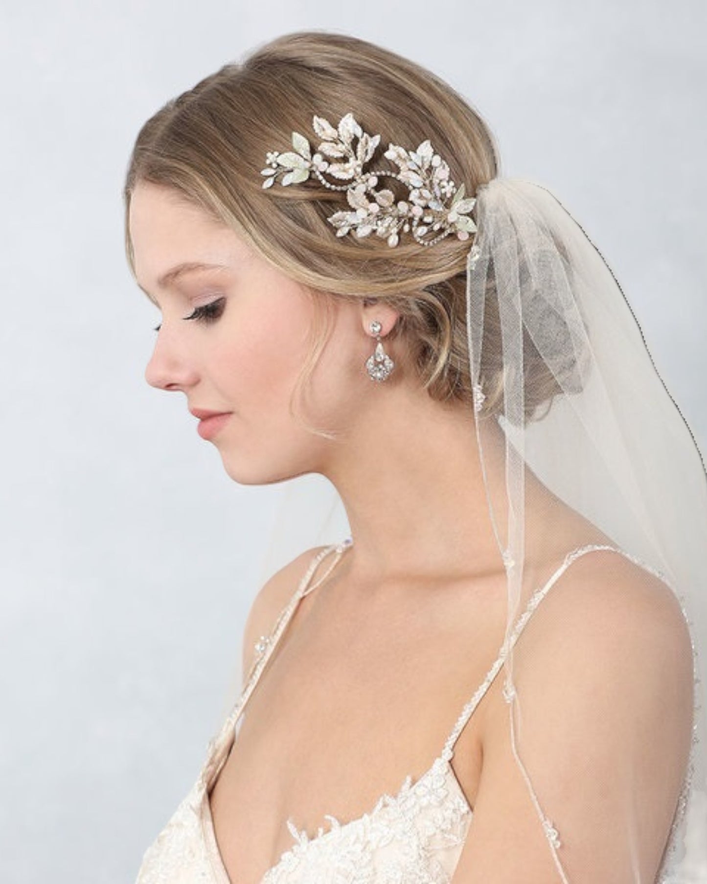 Delicado e floral pente para noivas produzido em base de metal com banho em champagne com flores e folhas levemente pintadas a mão em tons de rosa e verde finalizado com cristais e pérolas.