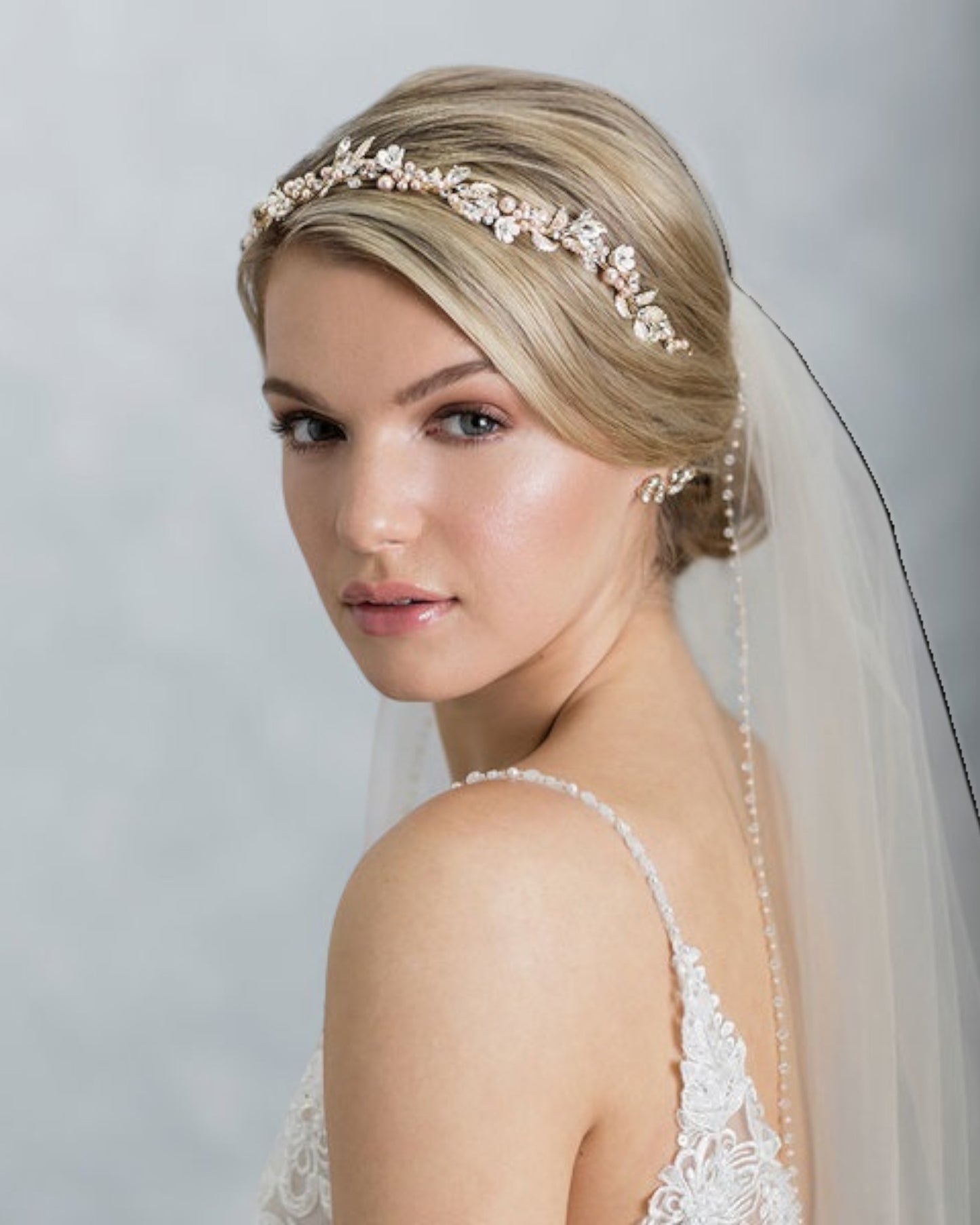 Leveza e delicadeza se unem para dar graça a esta tiara flexível para noivas. Com base em metal banhado em prata e adornada com cristais, pérolas rosadas e strass.