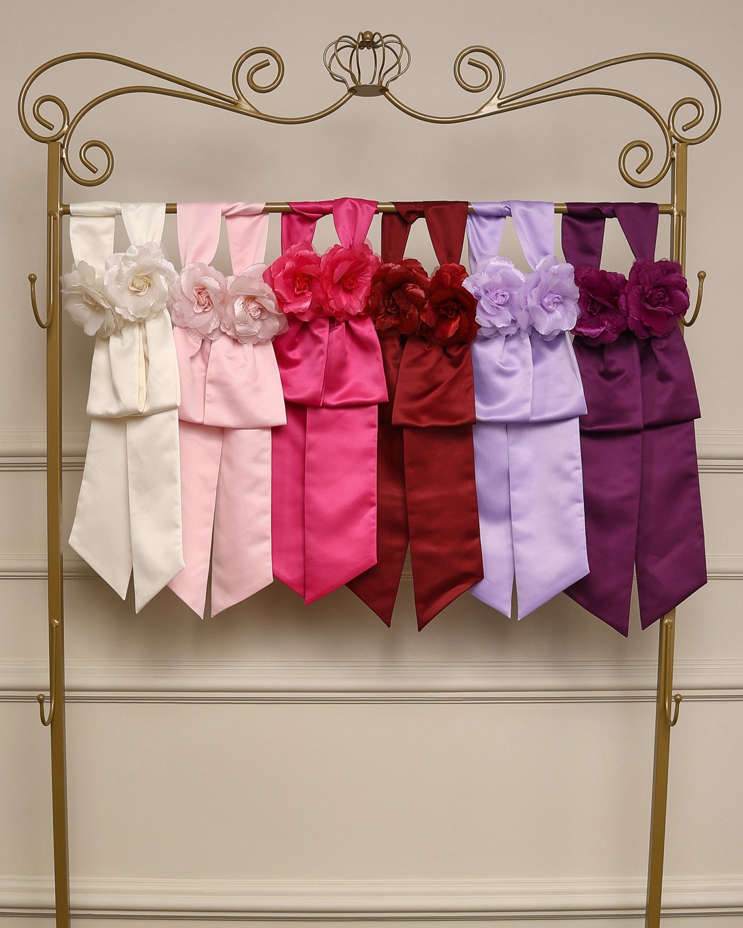 Faixa de cintura com flores em cetim da Etiquette, com broche floral e velcro, disponível para aluguel junto aos vestidos infantis