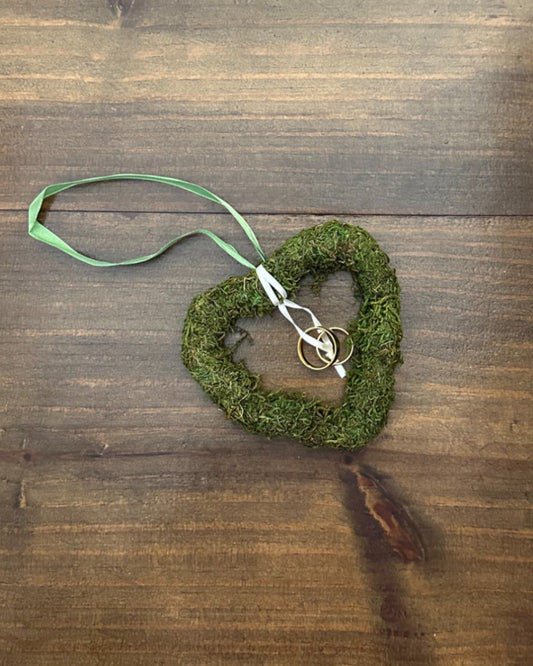 Mini porta alianças em formato de coração vazado com graminha sintética. Modelo leve e rústico-chic da Etiquette, ideal para casamentos no campo.